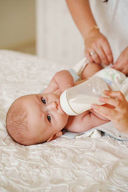istock Baby enjoys milk while lying on soft bed 2251957797