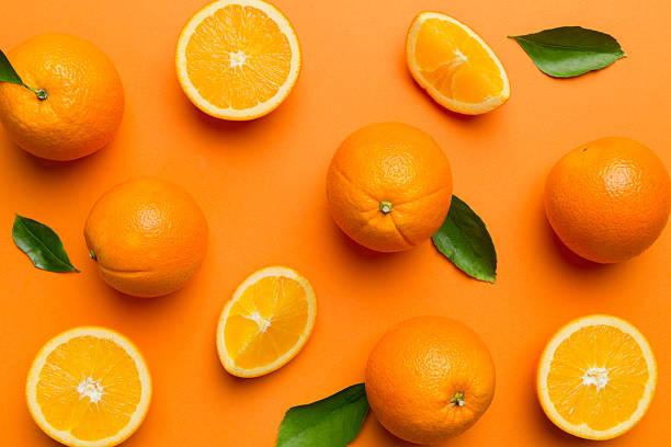 istock Fruit pattern of fresh orange slices on colored background. Top view. Copy Space. creative summer concept. Half of citrus in minimal flat lay 2251959385