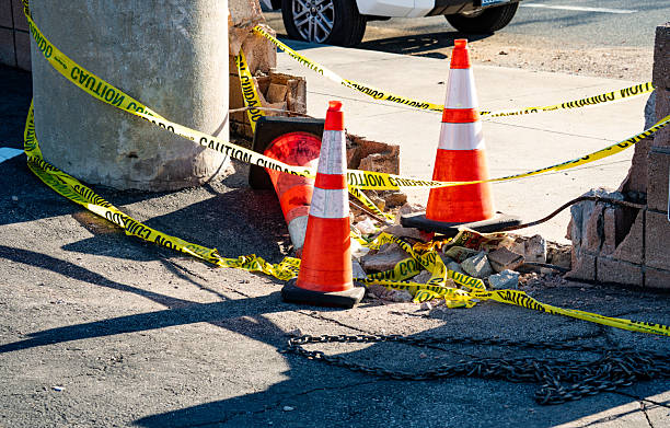 A pile of gravel and construction cones are seen on a street under the cover of night, reflecting ongoing infrastructure projects in the area.