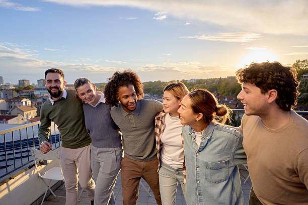 istock Happy friends talking while walking embraced on a patio at sunset. 2251961755