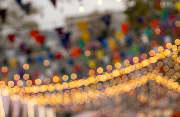 Defocused festive lights and colorful decorations at a Christmas bazaar in Baku, Azerbaijan, creating a vibrant bokeh background that represents holiday atmosphere, celebration, and winter festivities