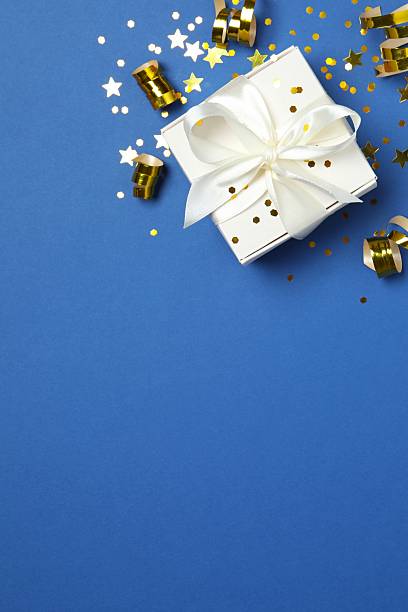 istock Beautiful gift box with confetti on color background, top view 2251968188