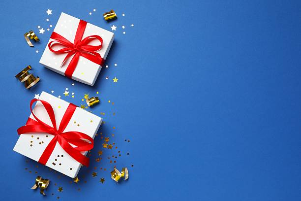 istock Beautiful gift boxes with confetti on color background, top view 2251968194