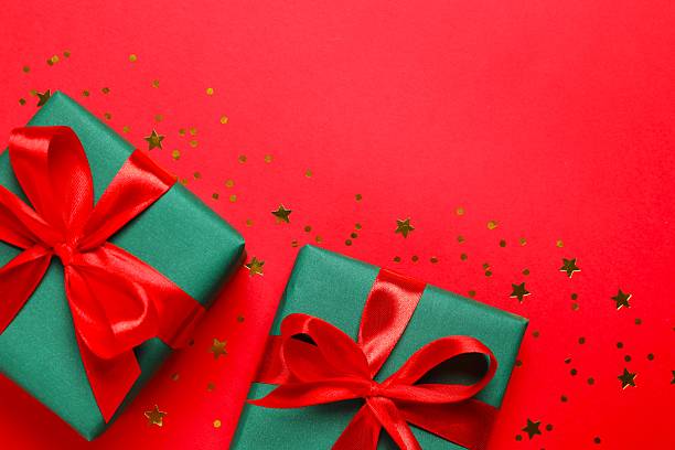 istock Creative Christmas gift boxes with confetti on color background, top view 2251968242