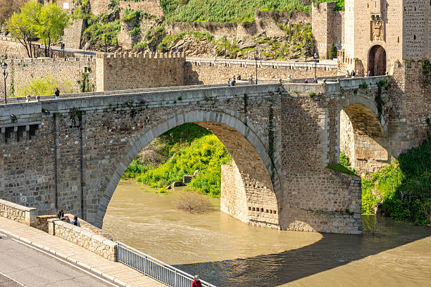 Toledo, Spain - 25 March 2025: Alcantara bridge over Tajo river in Toledo