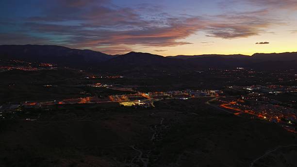 istock Mountain Town Night, Elevated Mountain Community Showcases Vibrant Lights Beneath Painted Sky 2251975843