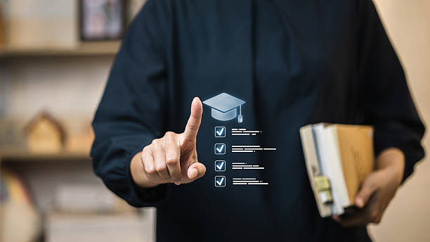 Adult student taps holographic graduation cap and checklist to plan academic requirements. Education app tracks course completion, learning goals, admissions tasks and study schedule.