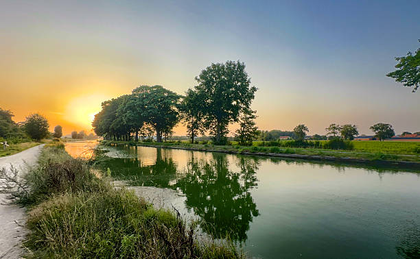 istock Serene countryside sunset with reflective trees and gentle mist 2251978625