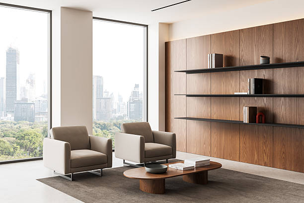 istock Modern minimalist office interior with wood panel wall, floating shelves and lounge chairs overlooking city skyline in natural light. 3D Rendering. 3D Rendering 2251981101
