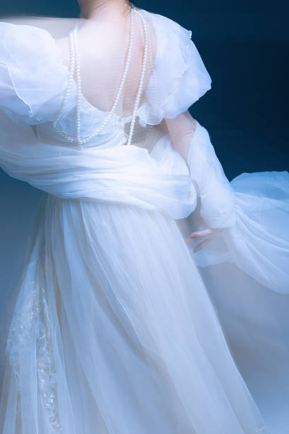 istock Flowing fabric and pearl strands in gentle motion, soft light and grace 2251981905
