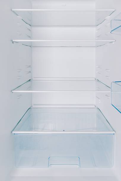 istock Clean, Empty Refrigerator Interior with Glass Shelves and Storage Drawer for Optimal Food Organization and Freshness Maintenance 2251982354
