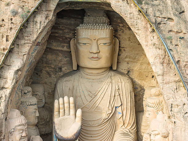 Stone Buddha at Yungang Grottoes, ancient Chinese Buddhist temple grottoes built during the Northern Wei dynasty near the city of Datong, in the province of Shanxi. They are excellent examples of rock-cut architecture and one of the three most famous ancient Buddhist sculptural sites of China. The others are Longmen and Mogao.