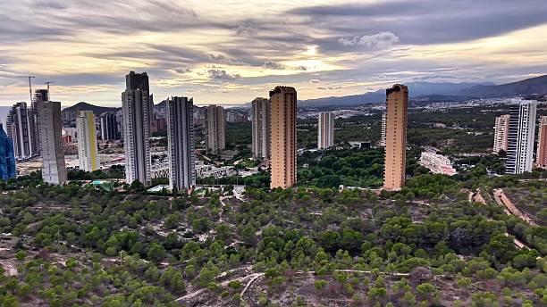 istock Dramatic Cloudfilled Sky Highlights Urban Development And Natural Landscape Interplay From Above 2251986883
