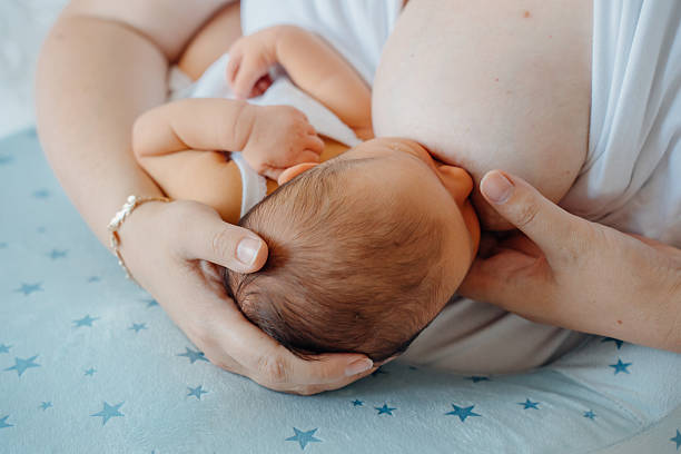 istock Mother nurses newborn during a quiet moment in home 2251987510