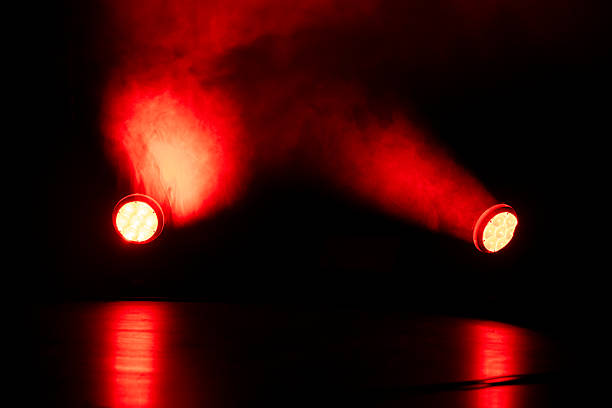 istock Red lights shine through thick smoke in a dark room during a performance 2251988421