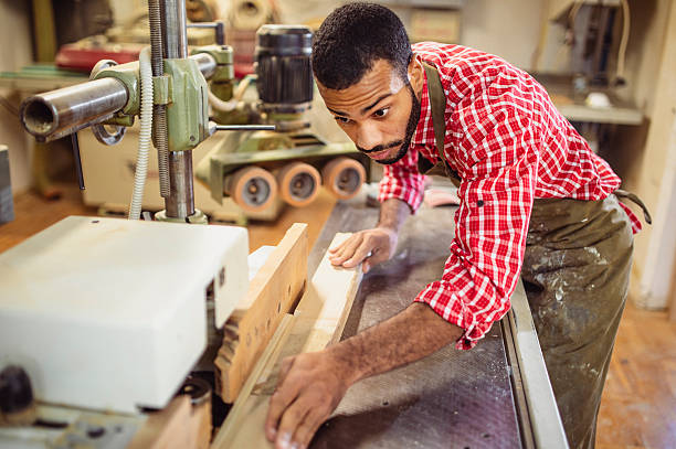 istock Diligent Multiracial Carpenter Operating Wood Planer in Workshop 2251988687