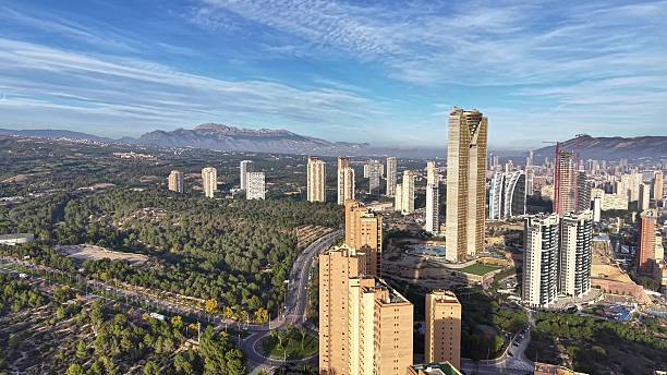 istock Aerial Daytime Panorama Capturing Luminous Architecture Amid Lush Valley And Mountain Range 2251992627