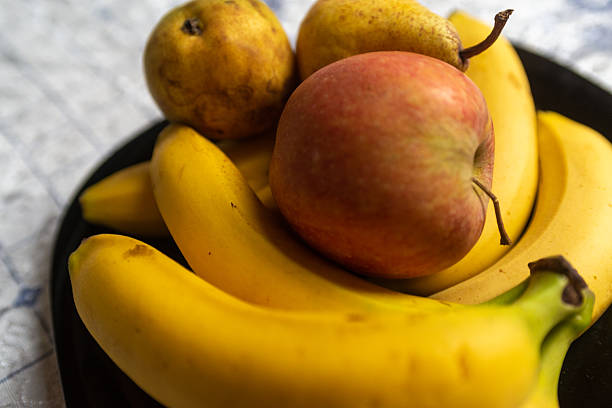 Organic fruit without chemicals and pesticides in a bowl. Apples, pears and bananas.