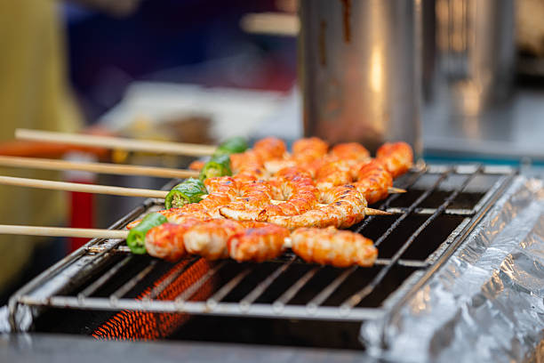 Grilled shrimp stay on barbecue.