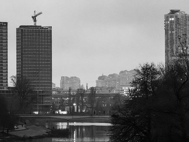 istock Urban skyline with cranes building new skyscrapers by river 2251994021