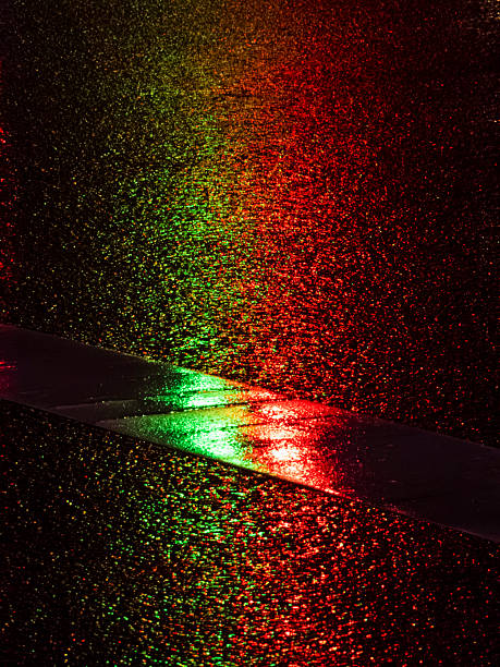 istock Wet asphalt reflecting bright red and green light at night 2251994847