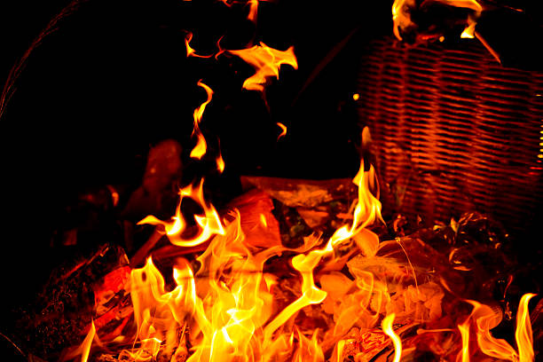 Large burning flames in vibrant yellow and red colors standing out against a dark black background. The image conveys intensity, heat, danger, and dramatic contrast. Suitable for concepts such as fire, energy, power, emergency, risk, destruction, or abstract backgrounds.