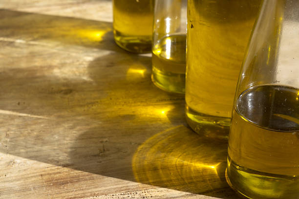 Natural setting with glass oiler with olive oil and olives