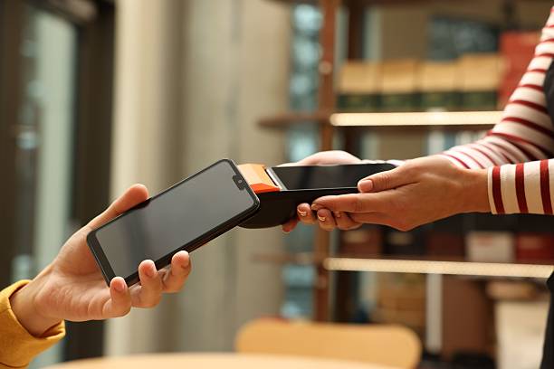istock Man paying with smartphone via terminal in cafe, closeup 2251997428