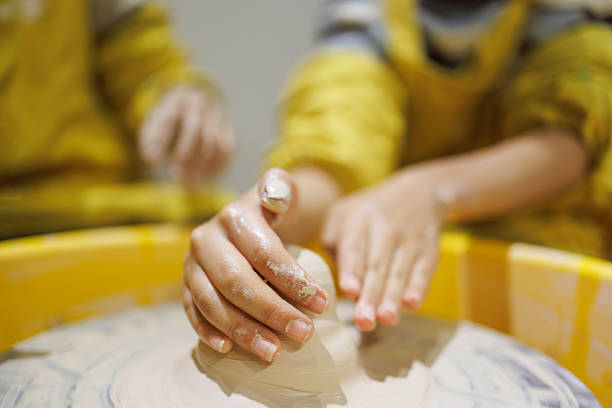 Close up shot of hands making pottery