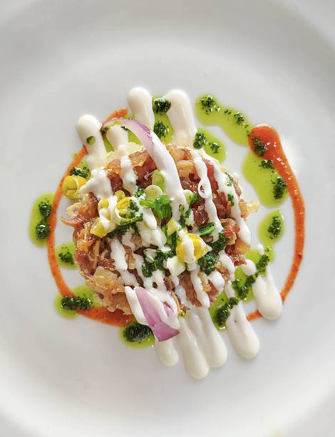 Crispy fried pig's ear accompanied by vegetables and three sauces