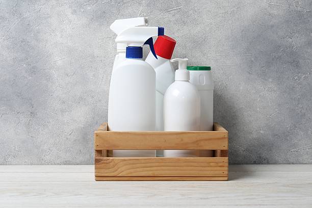istock Different cleaning products in crate on light wooden table 2251999146