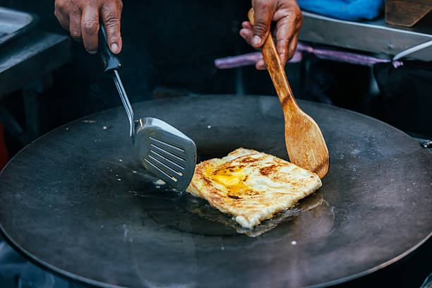 istock Unrecognizable person is cooking roti on cooking pan. 2252000563