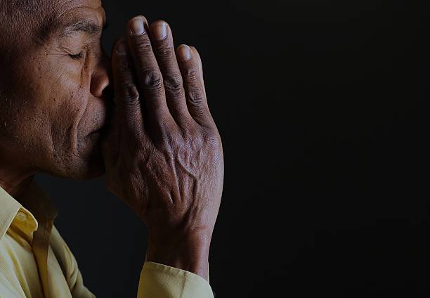 Elderly Woman Praying to God For Forgiveness