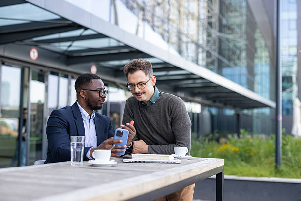 istock Business conversation between two men outdoors at a cafe 2252001738