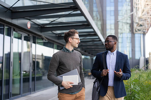 istock Two businessmen talking outdoors near office building 2252001741