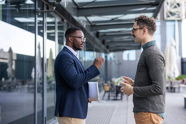 istock Two professional men discussing business outside modern office building 2252001779