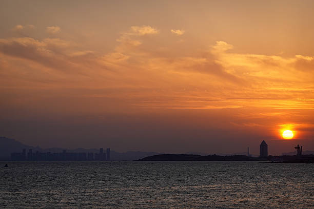 istock Orange Sunset Over Sea With Distant Lighthouse 2252001922