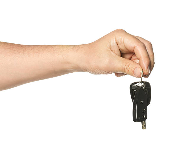 istock Man with car keys on white background, closeup 2252002392