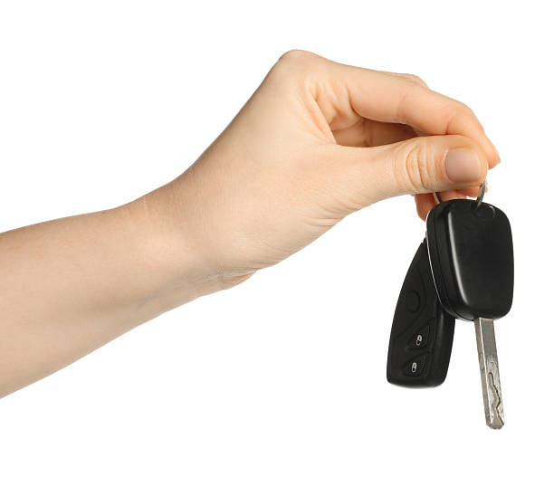 istock Woman with car keys on white background, closeup 2252002427
