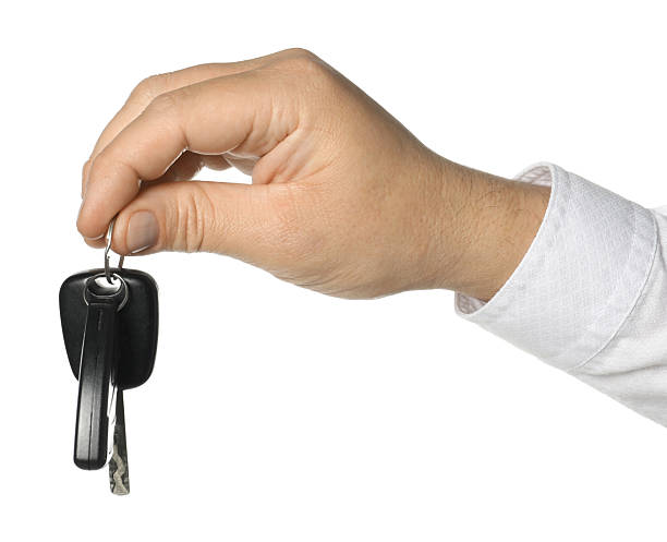 istock Man with car keys on white background, closeup 2252002460