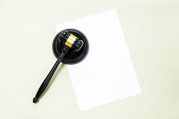 istock Judge's gavel and blank paper on a light green background. 2252003122