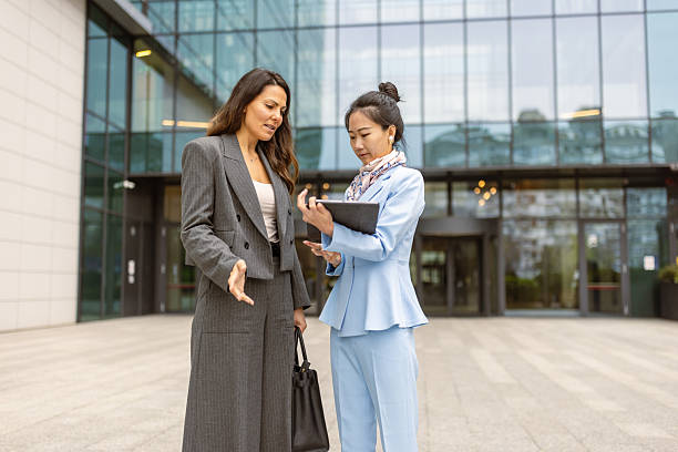 istock Businesswomen Discussing Strategy Outside Modern Office Building 2252004450
