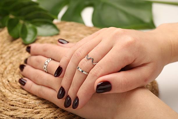 istock Woman wearing beautiful rings at white table, closeup 2252010362