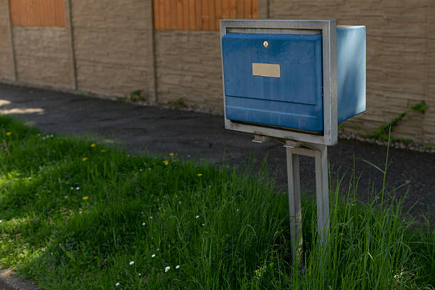 istock Public postal box situated among weeds and residential background 2252012415