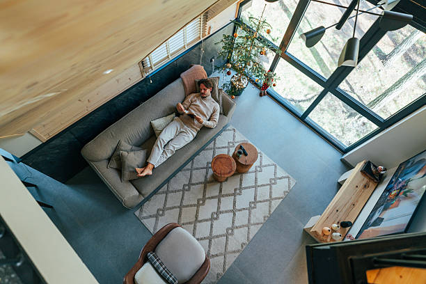 istock Man enjoying reading a book on a nice morning in a cozy mountain house 2252012633