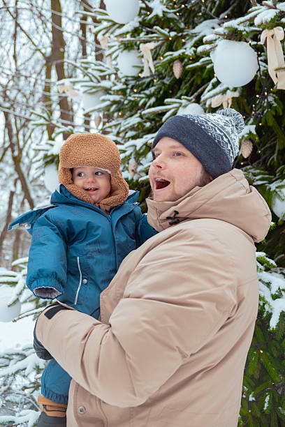 Mother and child enjoy a snowy day outside, interacting playfully. Dressed warmly in winter clothing, their joyous expressions capture the warmth and joy of the moment.