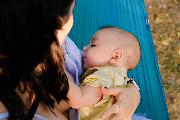 Mother and Baby Relaxing on a Hammock at Summer day