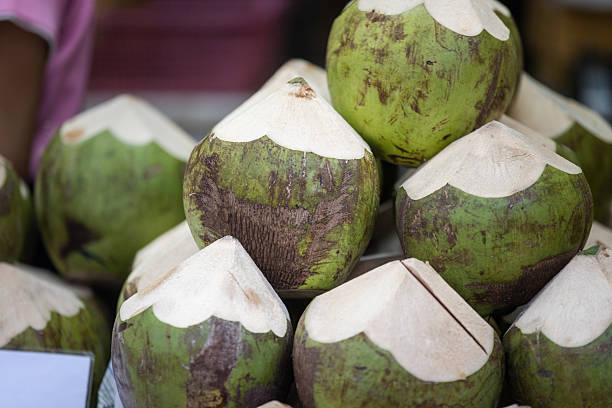 Fresh coconut sales on Asian street food market display.Local grocery, Phuket Old Town - Thailand.