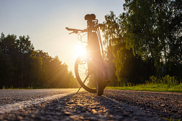 istock Road bike handlebar at sunny road. Riding a bicycle on empty highway. Bicycle handlebar . High quality photo 2252013983