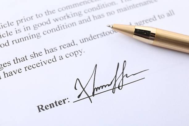 Signature and pen on paperwork, closeup view